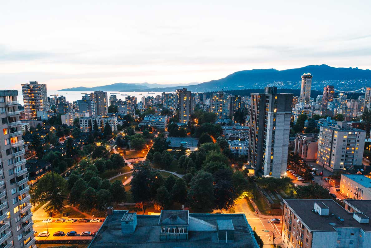 Downtown Vancouver buildings, ocean and mountains.